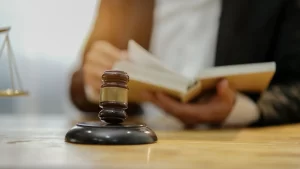 a motorcycle accident lawyer opening a book with a gavel on the table