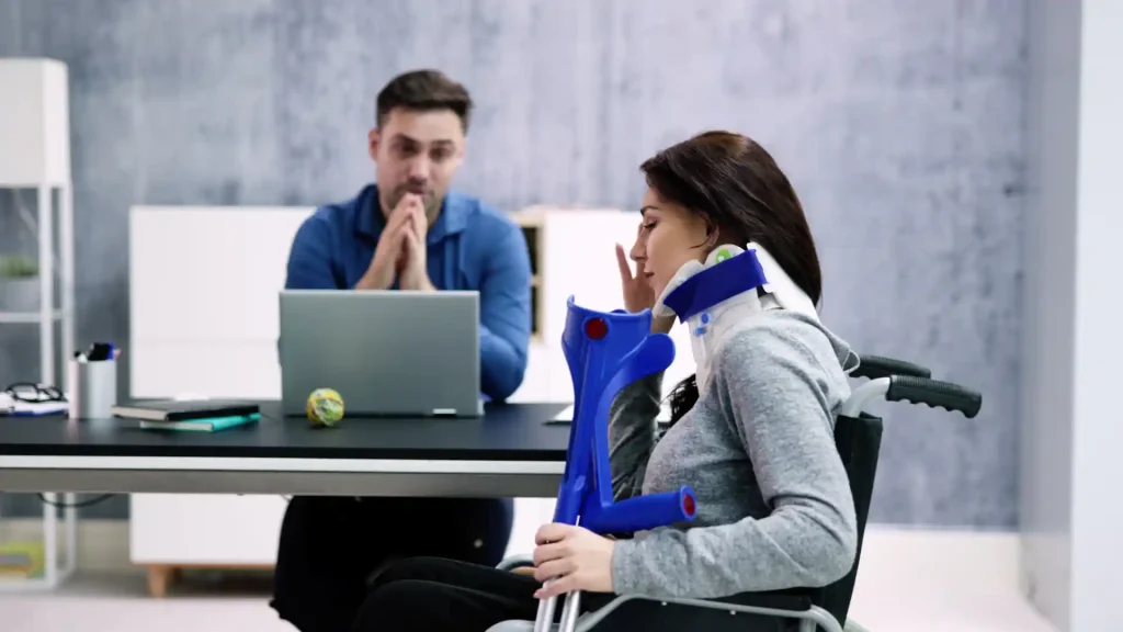 Injured woman with a neck brace and crutches talking to a concerned man at a desk.