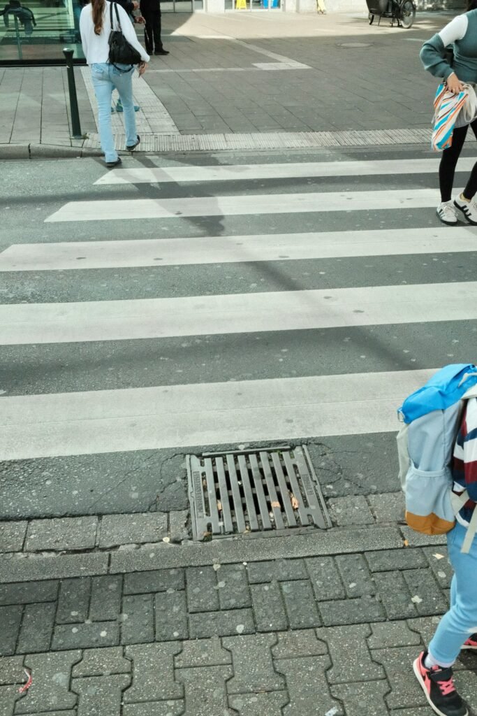 Pedestrians crossing a street at a crosswalk