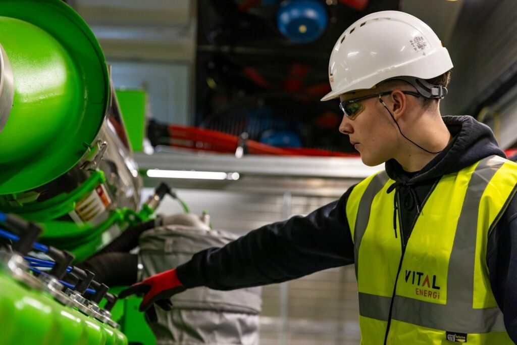 Worker in a hard hat and safety vest operating machinery