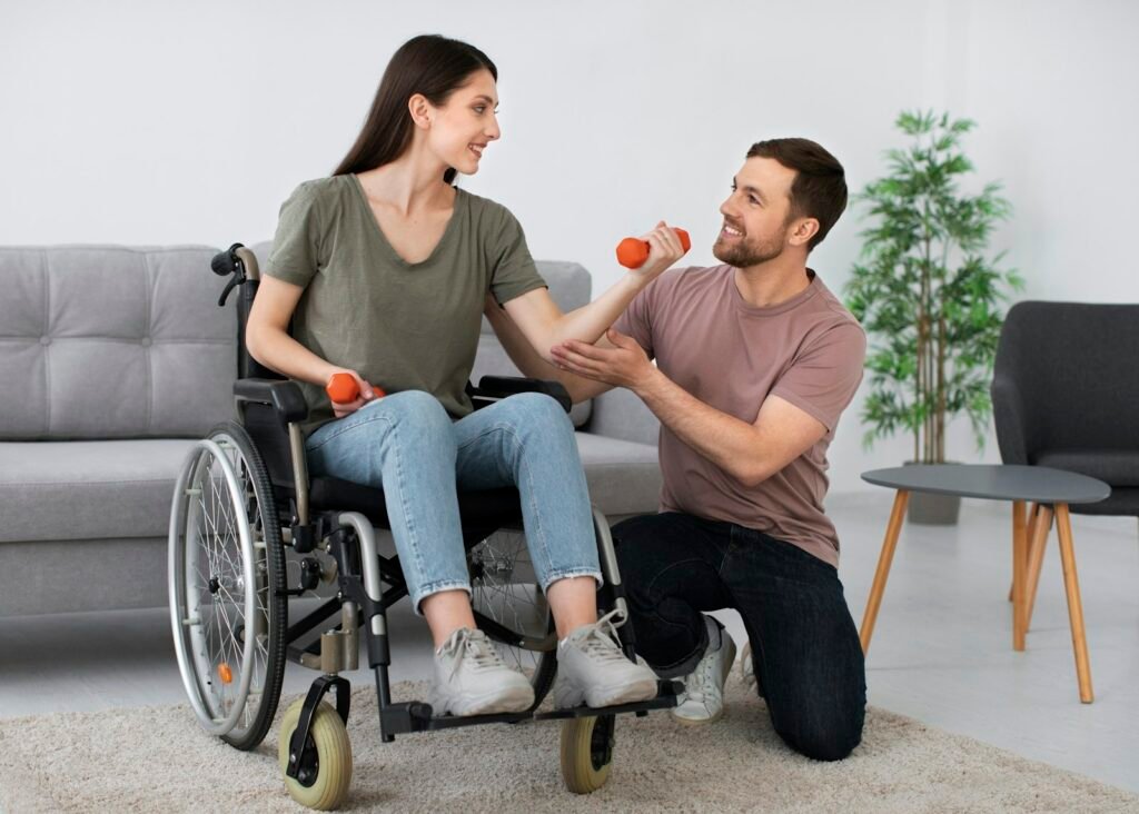 Woman in a wheelchair doing rehabilitation exercises with a caregiver