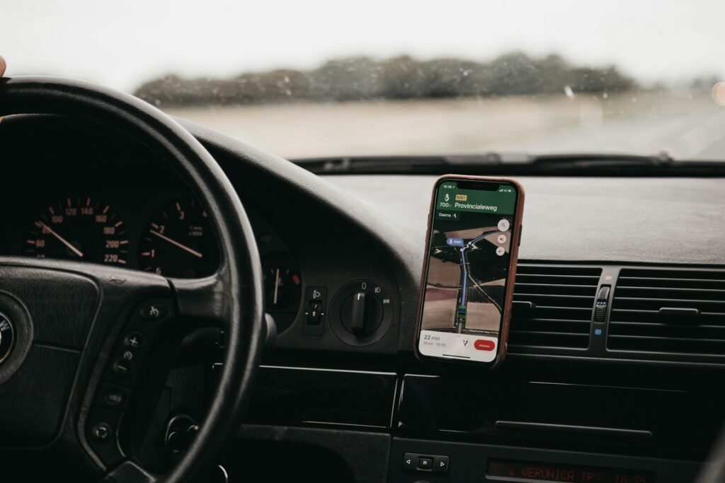 Smartphone with navigation app mounted on a car dashboard