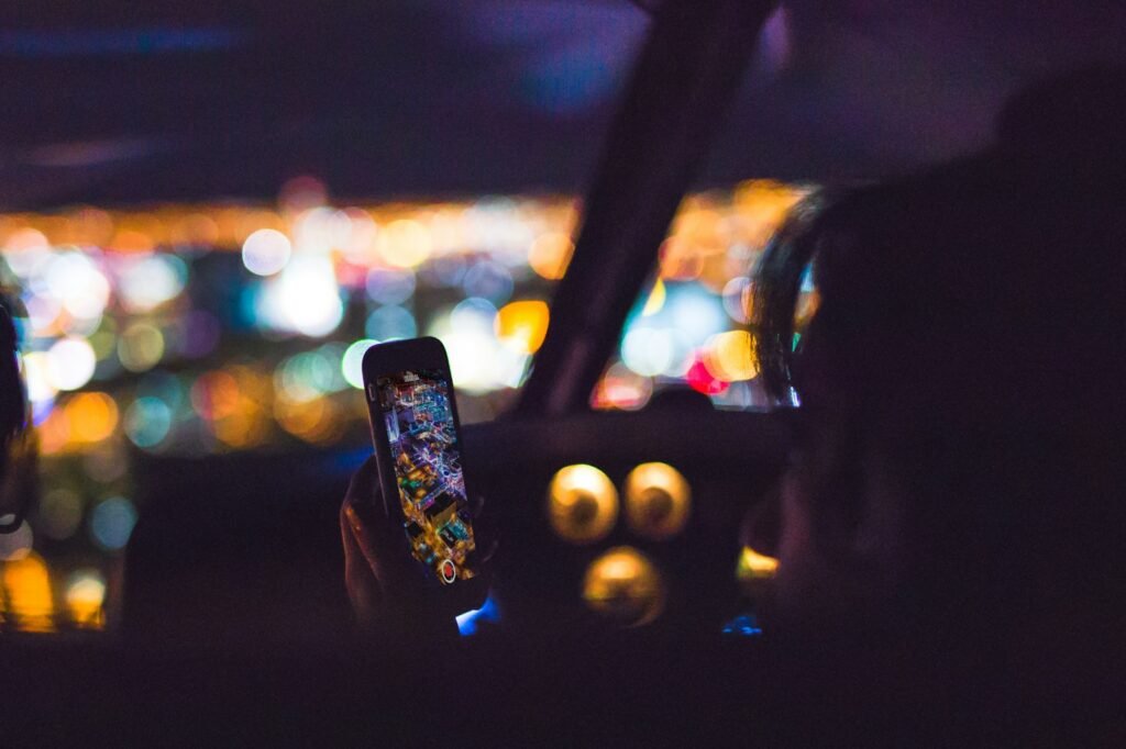 Passenger using a smartphone inside a car, representing a rideshare trip in Utah