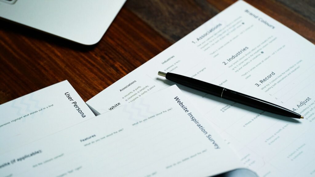 Pen resting on a stack of insurance paperwork
