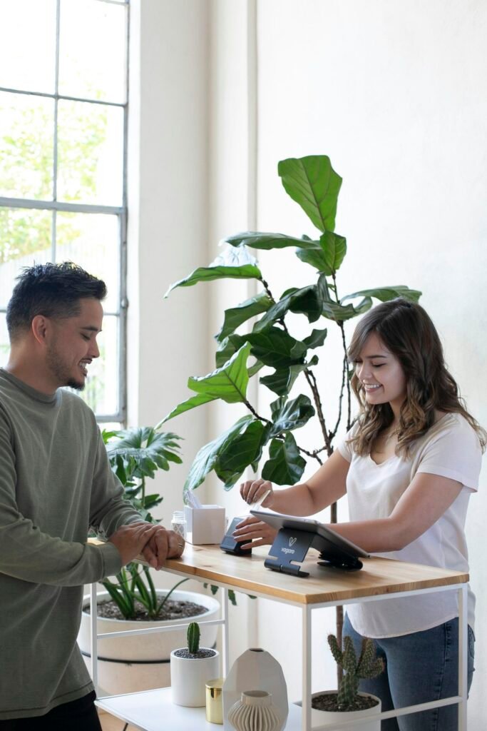 Two people shaking hands over an office desk