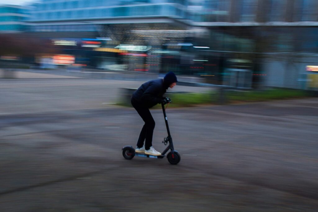 Person riding an electric scooter on a city street