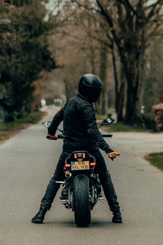 Motorcycle rider wearing a helmet on an open road