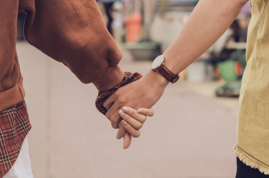 Two people holding hands for comfort